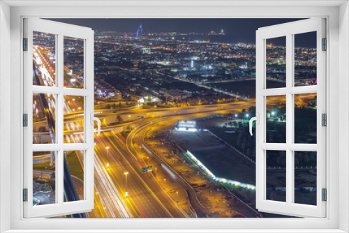 Fototapeta Naklejka Na Ścianę Okno 3D - Aerial view to traffic on Sheikh Zayed road and intersection night timelapse, Dubai, United Arab Emirates