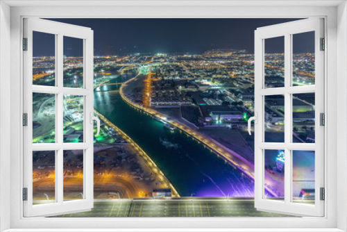Fototapeta Naklejka Na Ścianę Okno 3D - Dubai water canal with footbridge aerial night timelapse from Downtown skyscrapers rooftop
