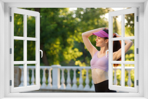 Fototapeta Naklejka Na Ścianę Okno 3D - Athletic girl running in the nature. Female jogging on bridge at the park. Young woman stretching before run. Fitness model working out outdoor. Concept of healthy lifestyle.