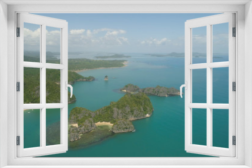Fototapeta Naklejka Na Ścianę Okno 3D - Aerial view of Groups islands with sand beach and turquoise water in blue lagoon among coral reefs, Caramoan Islands, Philippines. Mountains covered with tropical forest.