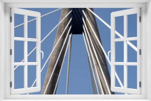 Fototapeta Naklejka Na Ścianę Okno 3D - a view of the tower and cables on the marine way suspension bridge in southport merseyside against a blue summer sky