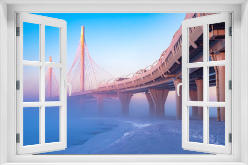 Fototapeta Naklejka Na Ścianę Okno 3D - Modern highway. Highway on stilts. Route on a foggy winter morning. Expressway. City road junction. The architecture of the bridges. Road viaduct.