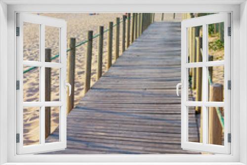 Fototapeta Naklejka Na Ścianę Okno 3D - Wooden walkway, people, beach, church