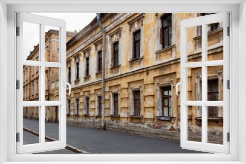 Fototapeta Naklejka Na Ścianę Okno 3D - gloomy old house. street with classical architecture of St. Petersburg, Russia. Dark houses with dark windows and a collapsing facade