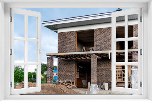 Fototapeta Naklejka Na Ścianę Okno 3D - Roofing Construction and Building New Brick House with Modular Chimney, Skylights, Attic, Dormers and Eaves.