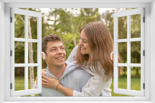 Christian friendship. Two happy friends laughing and hugging outdoors.