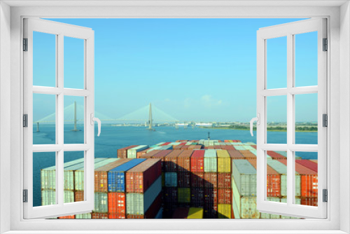 Fototapeta Naklejka Na Ścianę Okno 3D - Container ship approaching to the  Arthur Ravenel Jr. Bridge in Charleston, South Caroline.