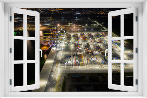 Fototapeta Naklejka Na Ścianę Okno 3D - Aerial view. Container ships in the harbor with bridges Crane Operates export and import business at sea at night. Logistics and transportation