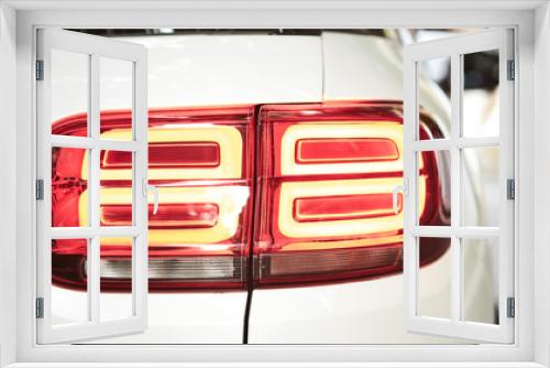 Fototapeta Naklejka Na Ścianę Okno 3D - Back lights of white car. While flaming red