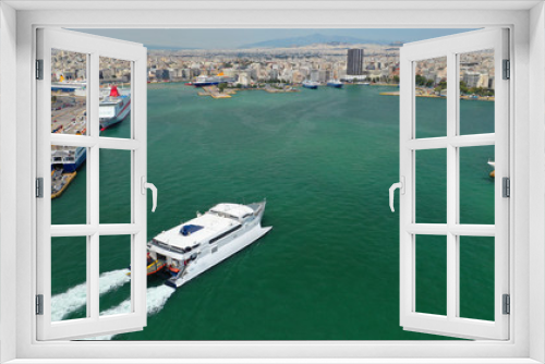 Fototapeta Naklejka Na Ścianę Okno 3D - Aerial drone photo of high speed passenger catamaran ferry approaching in low speed iconic port of Piraeus, Attica, Greece