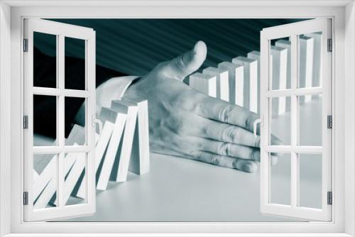 Fototapeta Naklejka Na Ścianę Okno 3D - Businessman Hand Stop Falling Domino Pieces