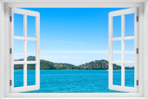 Fototapeta Naklejka Na Ścianę Okno 3D - View of a green island in the blue ocean