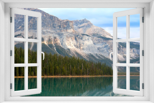 Fototapeta Naklejka Na Ścianę Okno 3D - A beautiful lake with high pine tree and big moutain in Banff Alberta Canada. Reflection of tree and mountain on lake.
