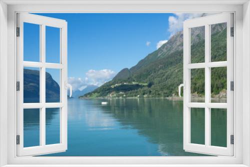 Fototapeta Naklejka Na Ścianę Okno 3D - Panoramic view of The Sognefjord (Sognefjorden), nicknamed the King of the Fjords. Te largest and deepest fjord in Norway. Symmetry created by reflections in the still ocean water. Bright midsummer.