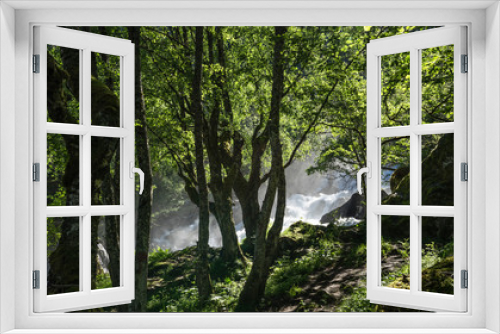 Fototapeta Naklejka Na Ścianę Okno 3D - Magnificent view  early midsummer morning in Norway. Hike through the forest to 218 metre high Feigefossen (Feigumfossen) waterfall. Mystical feeling, sun shining through the foliage, river streaming.