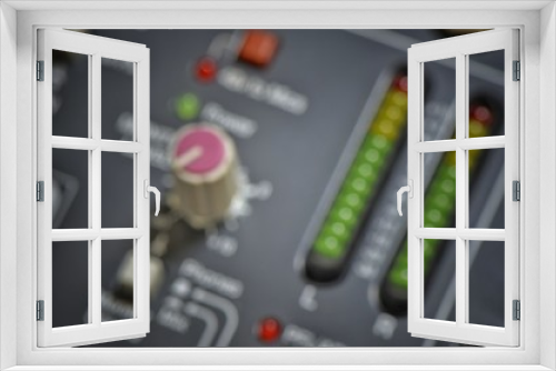 closeup of a audio mixer control panel blurred background