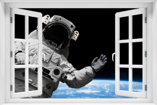 Fototapeta Naklejka Na Ścianę Okno 3D - astronaut waving during a spacewalk in orbit of planet Earth 