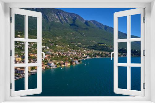 Fototapeta Naklejka Na Ścianę Okno 3D - Aerial photography with drone, on the medieval lakeside castle with a museum of history and paleontology, as well as a panoramic view from the tower. City of Malcesine on Lake Garda, Italy.