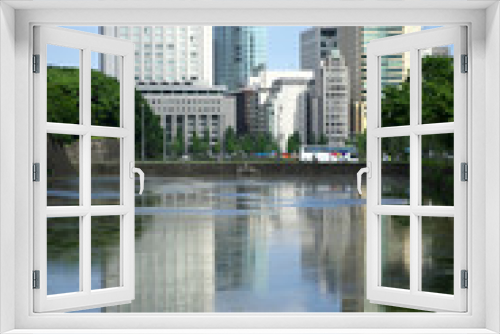 Fototapeta Naklejka Na Ścianę Okno 3D - Tokyo,Japan-July 27,2019: Water in moat reflecting buildings in Tokyo