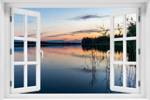 Fototapeta Naklejka Na Ścianę Okno 3D - Reflections on the calm waters of the Saimaa lake in Finland at Sunset  - 9