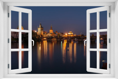 Fototapeta Naklejka Na Ścianę Okno 3D - Pananorma view over the river Vltava. Old Town Prague at night with the historic stone bridge. Charles Bridge with illuminated Old Town tower and reflections in the water