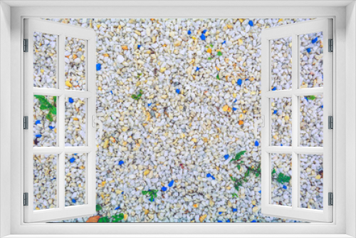 Fototapeta Naklejka Na Ścianę Okno 3D - Gravel texture of white, yellow, blue natural stone rubble, green grass plants