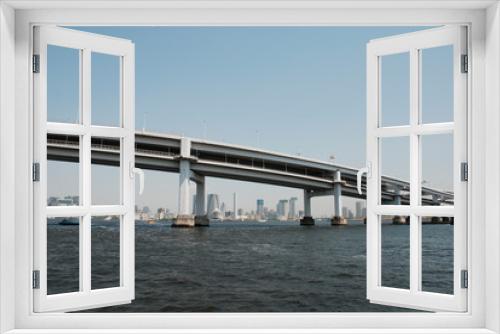 Fototapeta Naklejka Na Ścianę Okno 3D - A large modern bridge crosses one of Tokyo's waterways