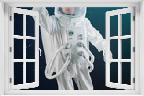 Fototapeta Naklejka Na Ścianę Okno 3D - astronaut flies over the earth in space, astronaut in space waving his hand