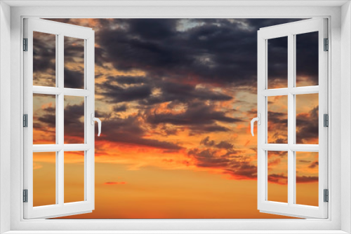 Fototapeta Naklejka Na Ścianę Okno 3D - Heavenly summer background. Beautiful bright majestic dramatic evening sky at sunset or sunrise orange and blue with rays. The sun shines over the horizon against the backdrop of thunder clouds