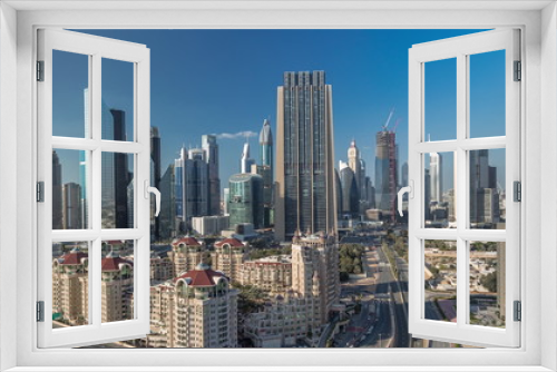 Fototapeta Naklejka Na Ścianę Okno 3D - Skyline view of the buildings of Sheikh Zayed Road and DIFC timelapse in Dubai, UAE.