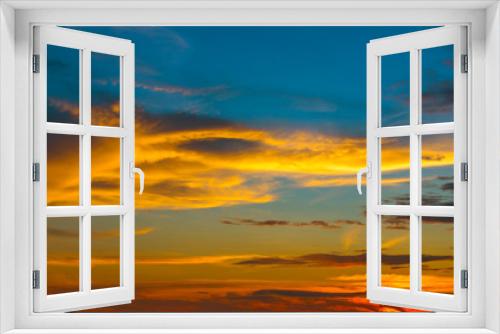 Fototapeta Naklejka Na Ścianę Okno 3D - Beautiful Sunset in the sky with sky blue and orange light of the sun through the clouds in the sky, Orange and red dramatic colors - Image
