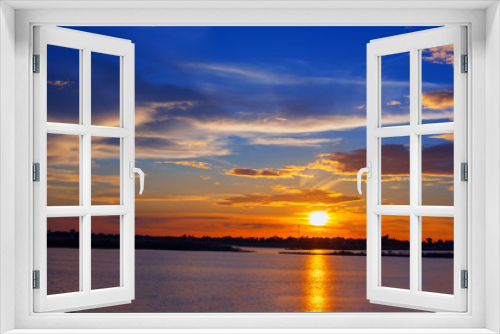 Fototapeta Naklejka Na Ścianę Okno 3D - Beautiful Sunset in the sky with sky blue and orange light of the sun through the clouds in the sky, Orange and red dramatic colors over the sea. - Image