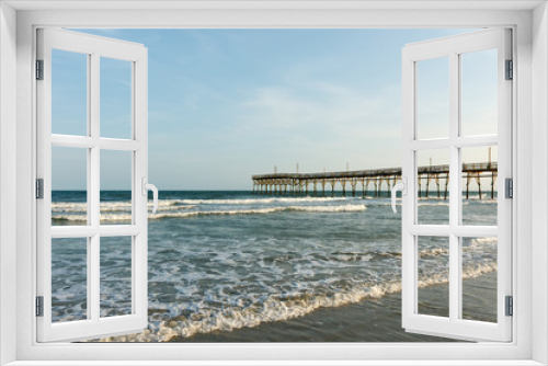 Fototapeta Naklejka Na Ścianę Okno 3D - Pier into the Atlantic Ocean, Sunset Beach, North Carolina; with copy space for text, at sunrise