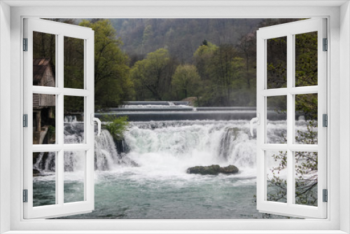 Fototapeta Naklejka Na Ścianę Okno 3D - Dramatic shot of a layered waterfall on the river Una in Bosnia-Herzegovina with a lot of water vapor in the early morning.