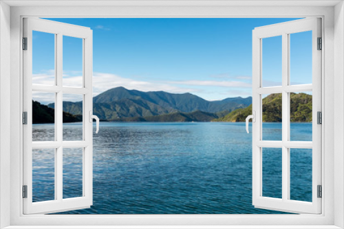 Fototapeta Naklejka Na Ścianę Okno 3D - A low-level view of the beautiful and stunning Marlborough Sound and the surrounding hills at the top of the South Island, New Zealand on a sunny day.