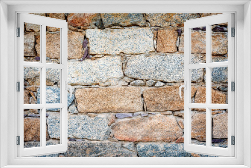 Fototapeta Naklejka Na Ścianę Okno 3D - Detail of an old stone wall arranged in an irregular manner with vignette corners. Architecture constructions. Vintage background.
