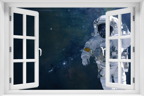Fototapeta Naklejka Na Ścianę Okno 3D - Astronaut on background of cosmic landscape. Nebulae and star clusters of deep space. Science fiction. Elements of this image furnished by NASA