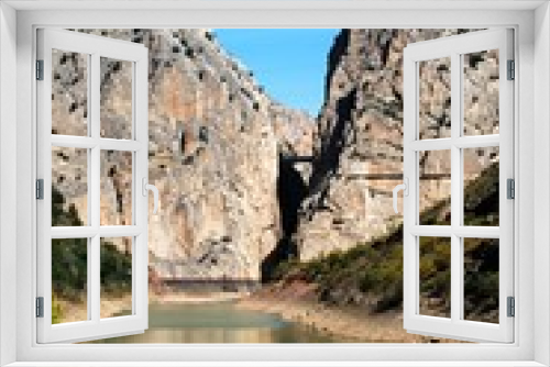 Fototapeta Naklejka Na Ścianę Okno 3D - View of the gorge and lake with the Devils Bridge to the rear, El Chorro, Andalusia, Spain.