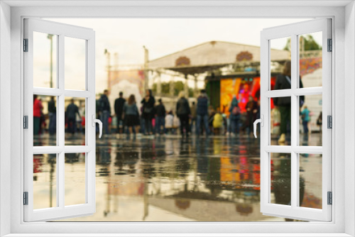 Defocused photo of people on the city festival. Indian Culture Day in Moscow on a summer rainy day. Unrecognizable faces.