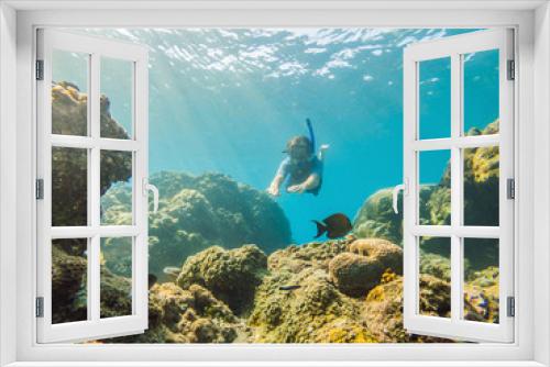 Fototapeta Naklejka Na Ścianę Okno 3D - Happy man in snorkeling mask dive underwater with tropical fishes in coral reef sea pool. Travel lifestyle, water sport outdoor adventure, swimming lessons on summer beach holiday. Aerial view from
