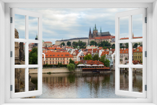 Fototapeta Naklejka Na Ścianę Okno 3D - View of statues on the Charles Bridge (Karluv most), Mala Strana District (Lesser Town), Prague (Hradcany) Castle and St. Vitus Cathedral in Prague, Czech Republic, on a cloudy day.