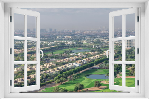 Aerial view to villas and houses with Golf course with green lawn and lakes timelapse