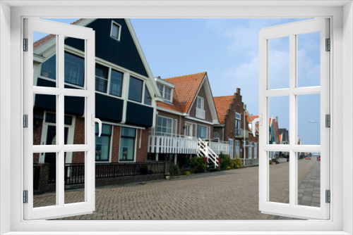 Fototapeta Naklejka Na Ścianę Okno 3D - The Netherlands (aka Holland), Volendam. Popular picturesque fishing village on the IJsselmeer. Typical homes along dike.