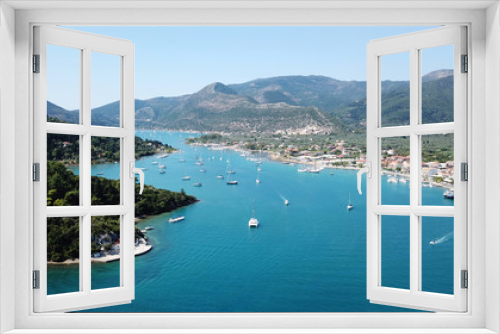 Fototapeta Naklejka Na Ścianę Okno 3D - Aerial drone bird's eye view photo of iconic port of Nidry or Nydri a safe harbor for sail boats and famous for trips to Meganisi, Skorpios and other Ionian islands, Leflkada island, Ionian, Greece