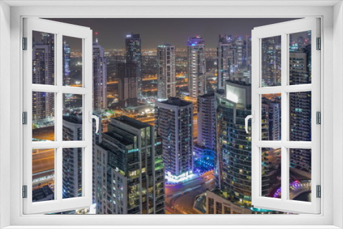 Fototapeta Naklejka Na Ścianę Okno 3D - Aerial top view of Dubai Marina night timelapse. Modern towers and traffic on the road