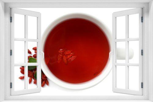Fototapeta Naklejka Na Ścianę Okno 3D - Healthy goji tea in cup with berries on white background, top view