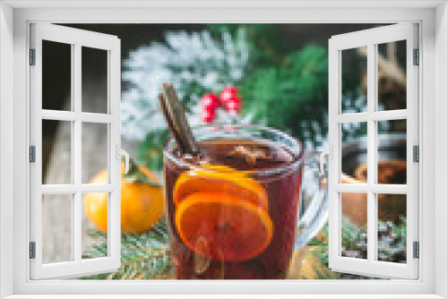 Fototapeta Naklejka Na Ścianę Okno 3D - Christmas mulled red wine with spices and fruits on a wooden rustic table. Traditional hot drink at Christmas time