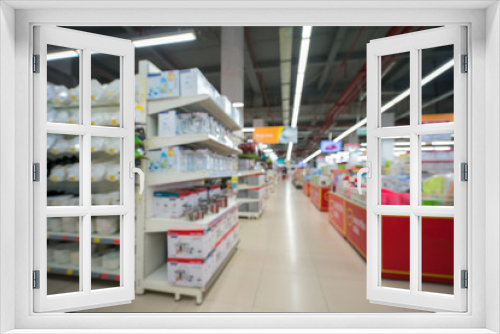 Supermarket blurred background with colorful shelves and unrecognizable customers