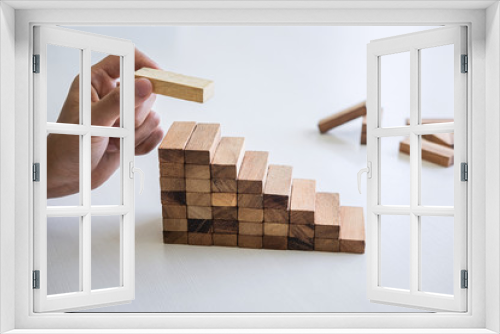Fototapeta Naklejka Na Ścianę Okno 3D - Alternative Risk and Strategy in business to make growth, Image of Business man's hand placing making a wooden block stacking hierarchy on growing to lay the foundation and development to successful