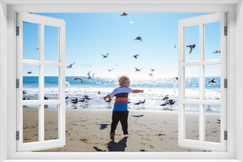 Fototapeta Naklejka Na Ścianę Okno 3D - Happy and free boy on the beach with seagulls